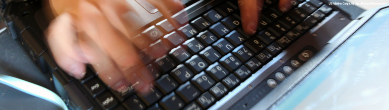 Person typing on keyboard.