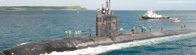 A surfaced submarine with men on top.